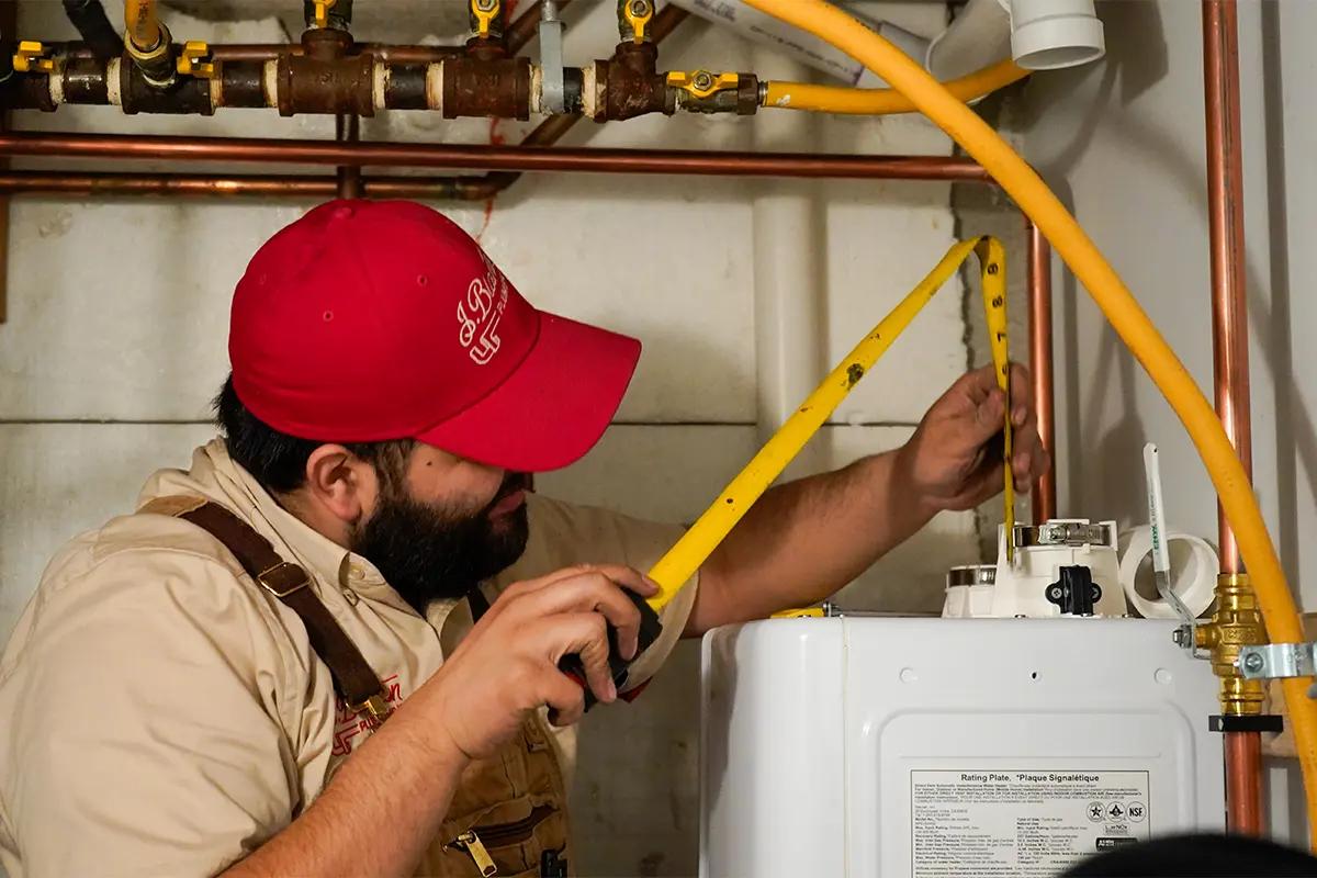 J. Blanton plumber measuring for a water heater installation