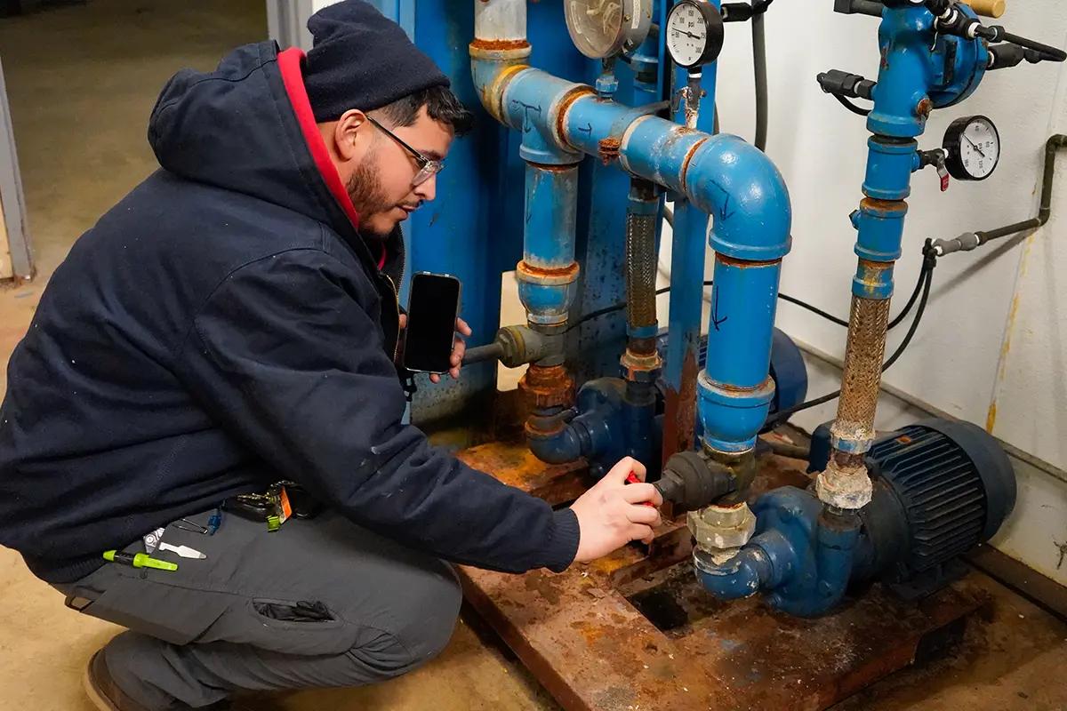 J. Blanton plumber checking a commercial pump system