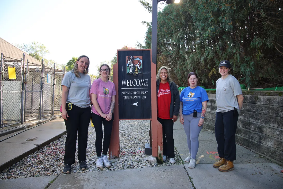 J. Blanton Plumbing and Orphans of the Storm team members at the shelter's welcome sign