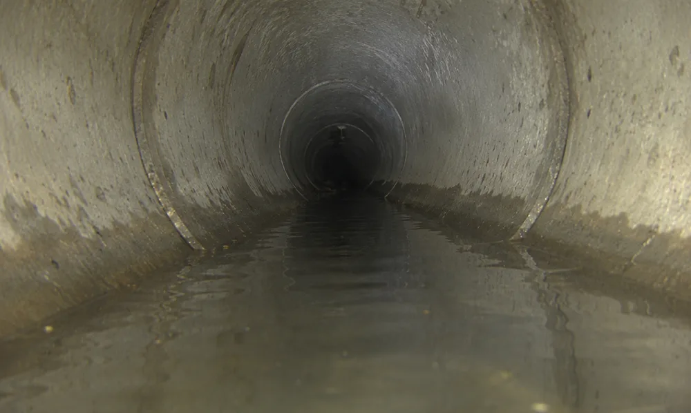Standing water pooled in a low spot, or belly, of a sewer pipe