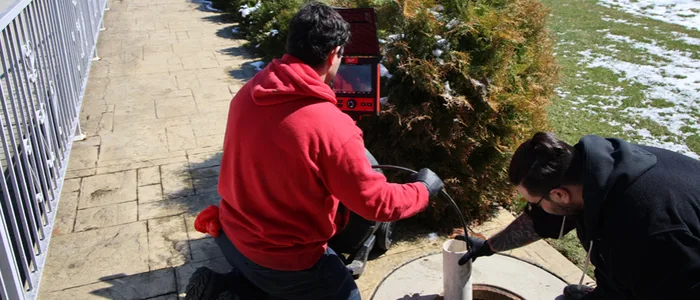 J. Blanton crew members working together on a Chicago sewer line inspection