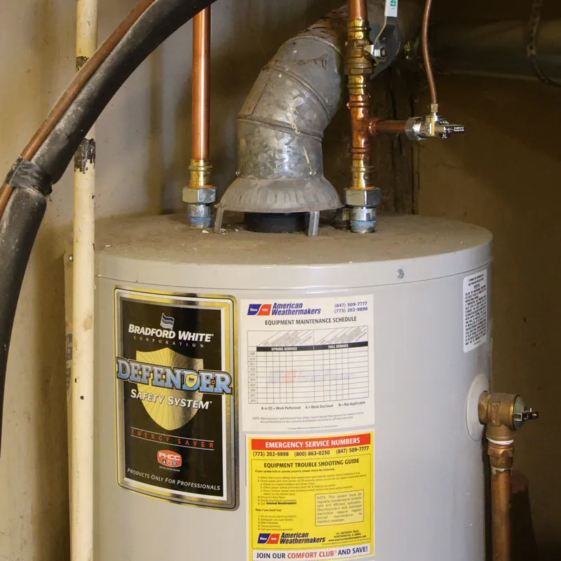 Bradford White tank water heater with copper supply lines and vent pipe